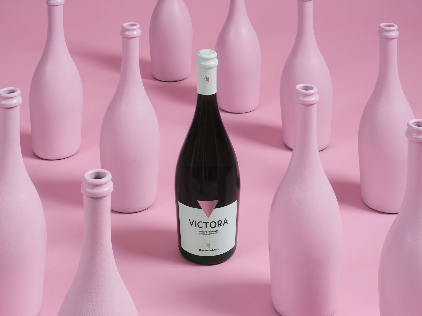 Victora sparkling rosé among pink-painted bottles, on a pink ground