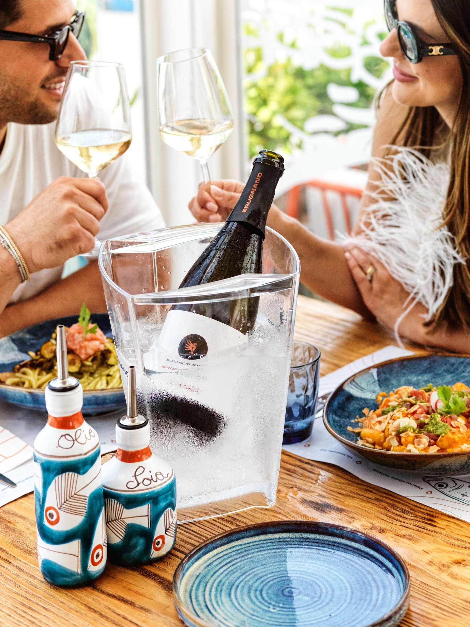 A laid table with ice bucket, glasses and dishes: an image for social