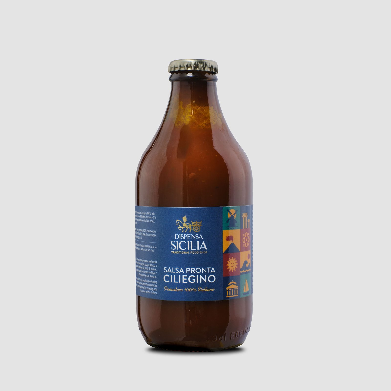 Dispensa Sicilia ready-made cherry tomato sauce in an amber glass bottle, on a light background