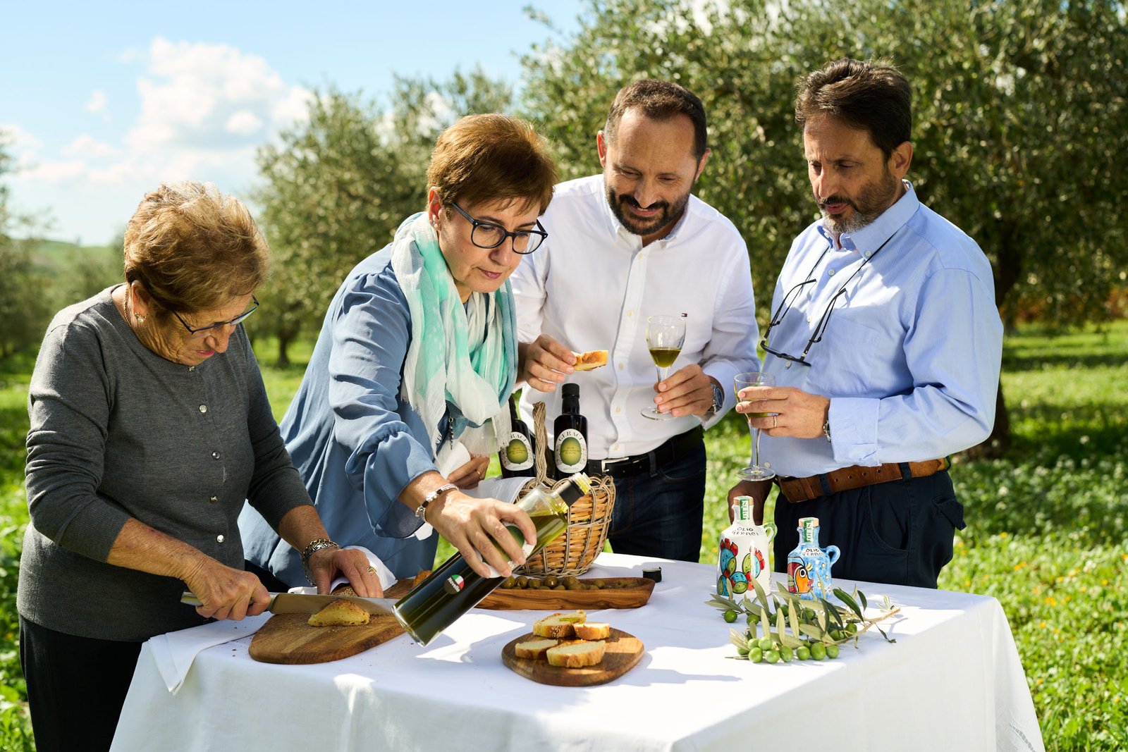 The family around the table: bread, olives and freshly poured oil