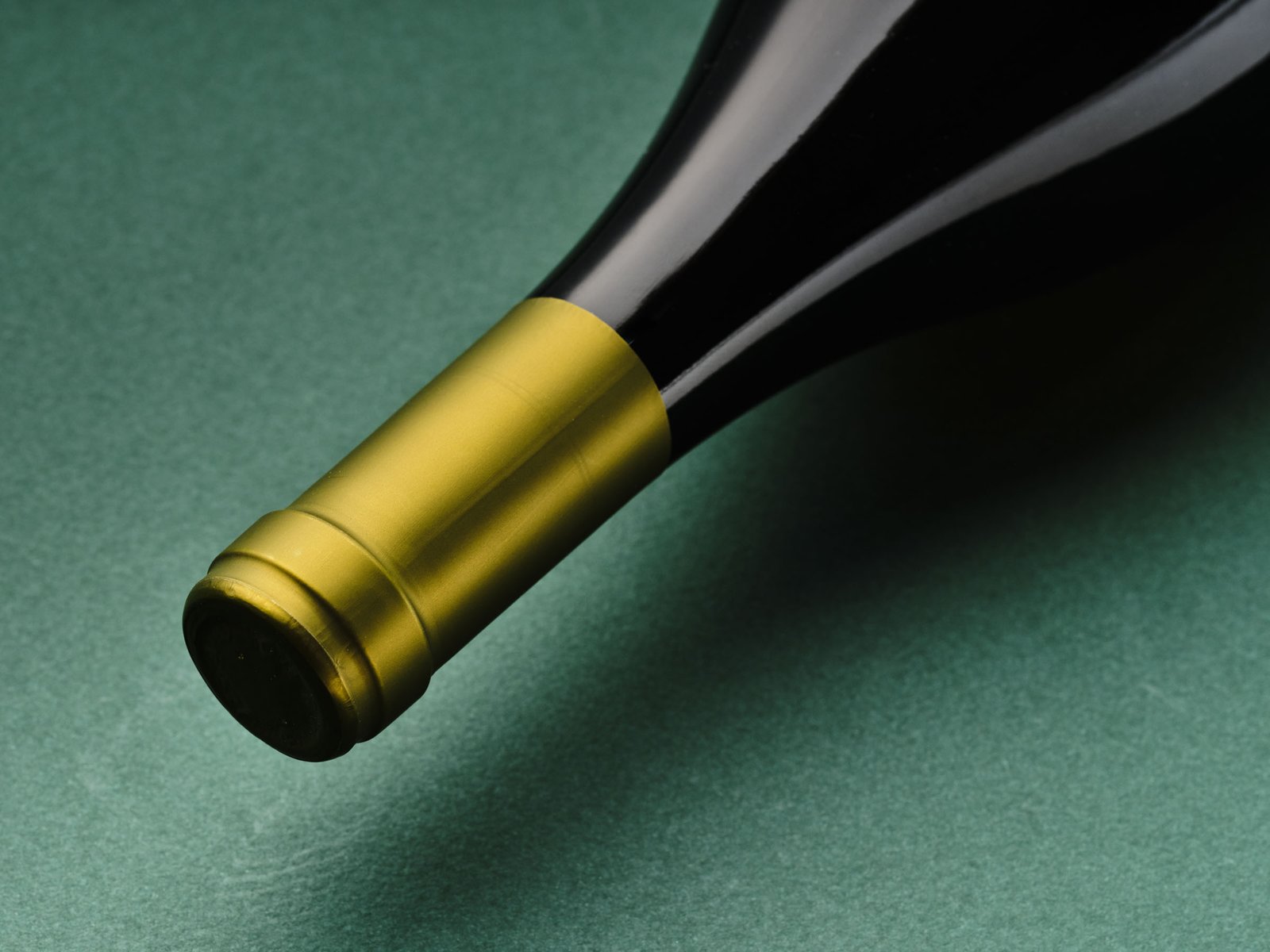 Gold capsule of the Terre dei Miti Etna Bianco on green paper